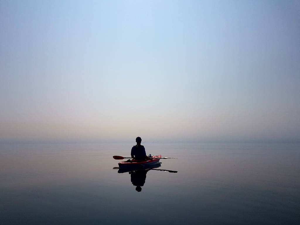 My Personal Florida Travel Bucket List 4 Kayaker on calm water at dusk