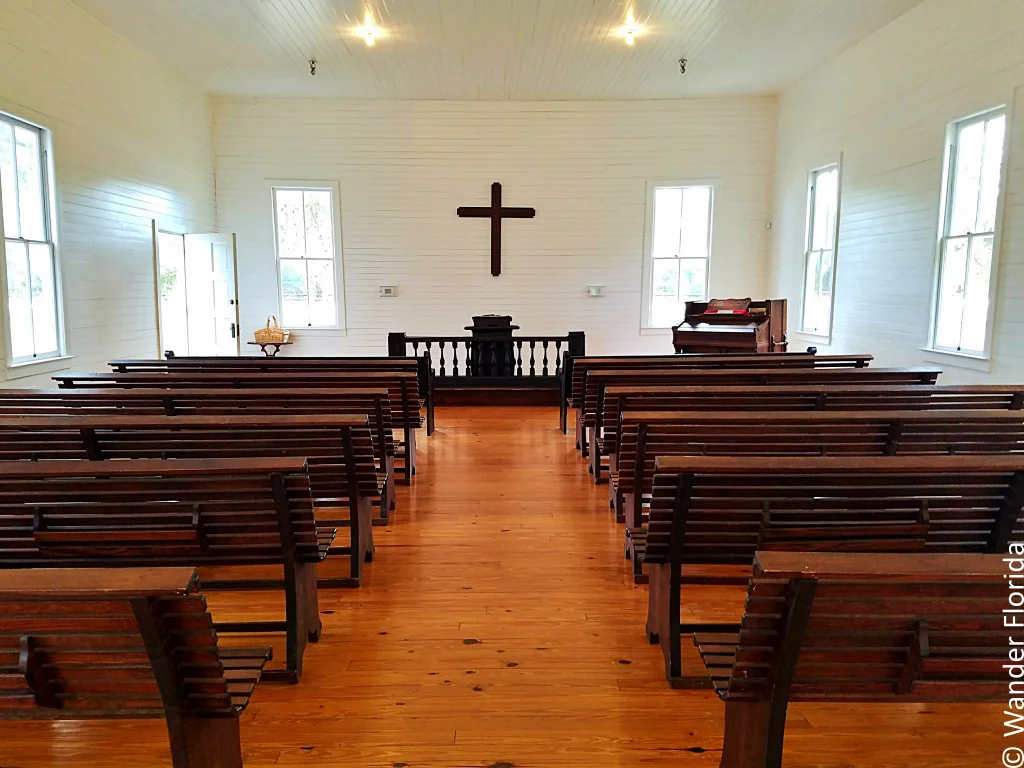 The interior of Safety Harbor Church at Heritage Village still holds the original railing, altar, and pulpit.