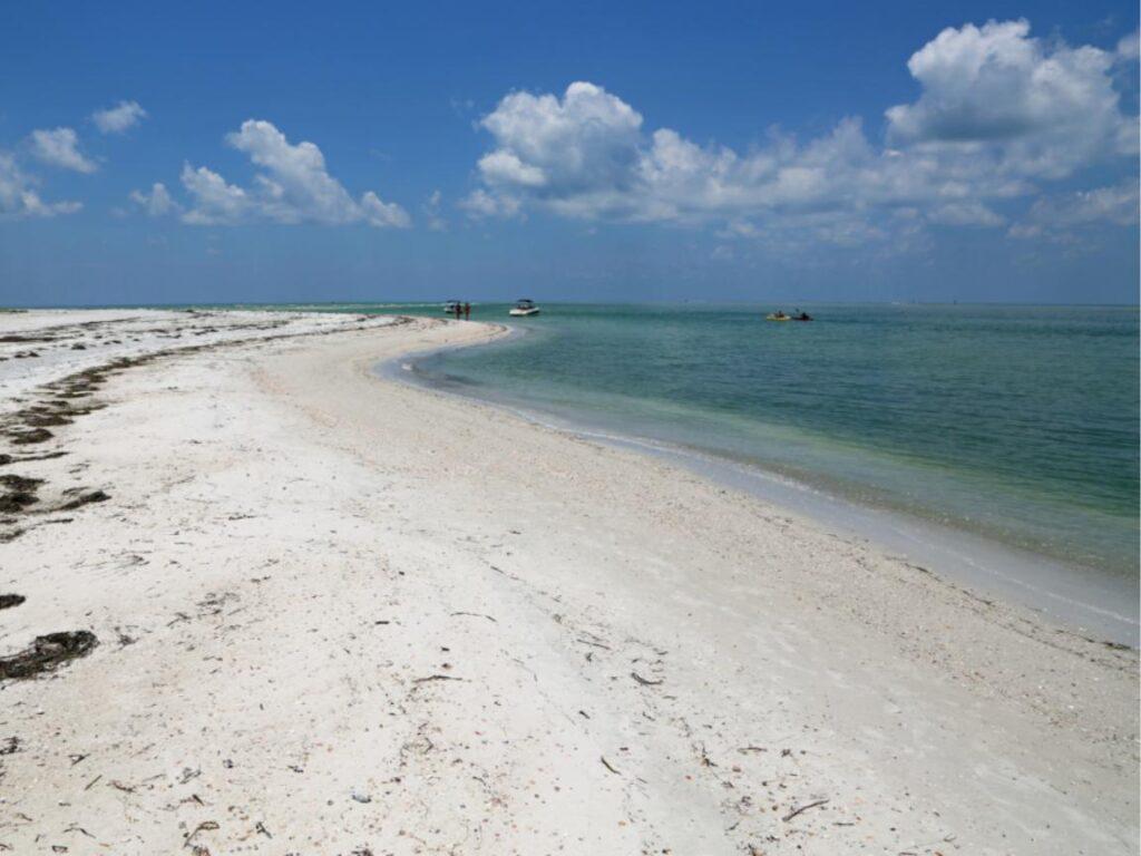 13 Romantic Beaches in Florida Offer the Perfect Couple's Getaway 8 Caladesi Island, one of Florida's most romantic beaches, with a wide sandy beach on the left and the turquoise waters of the Gulf of Mexico on the right.