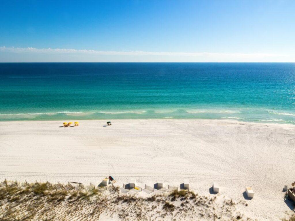 13 Romantic Beaches in Florida Offer the Perfect Couple's Getaway 12 Aerial view of the sand and green waters of Destin Florida's romantic beach.