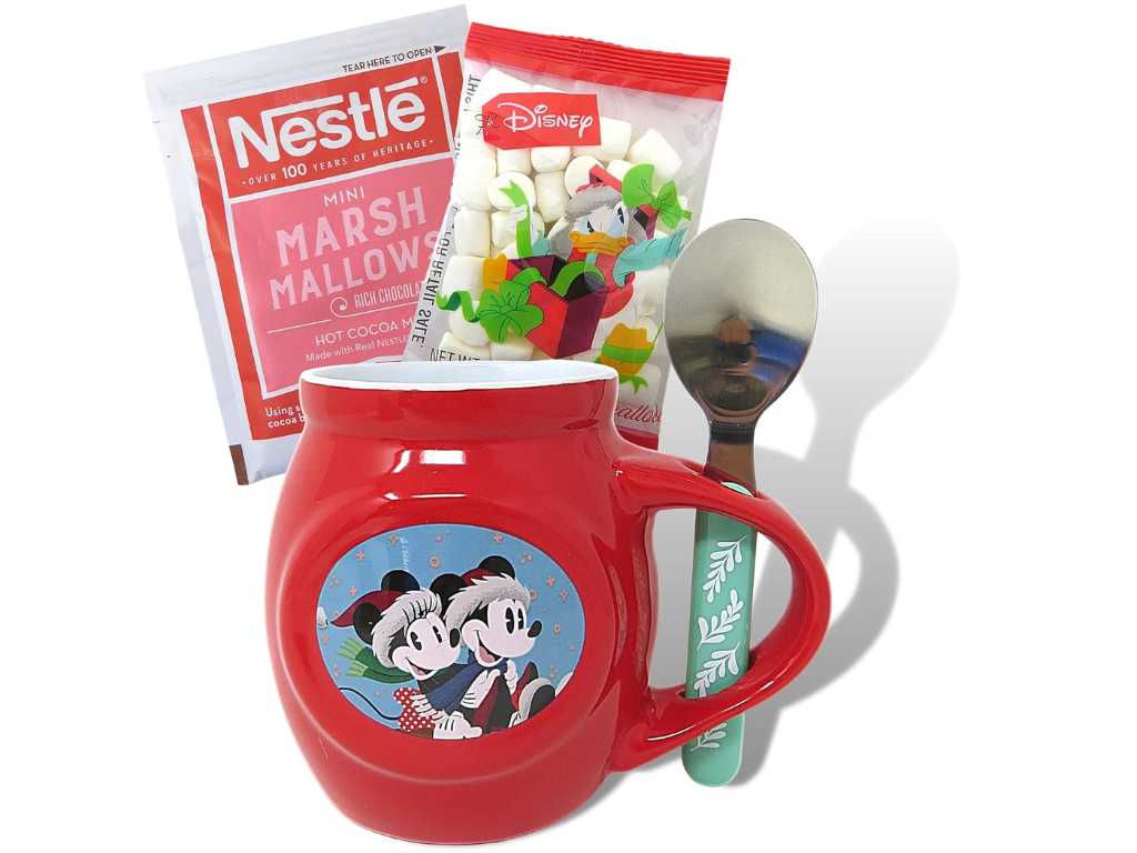 Red mug with Mickey and Minnie in Santa hats, a teal-handled spoon, and packets of hot cocoa.