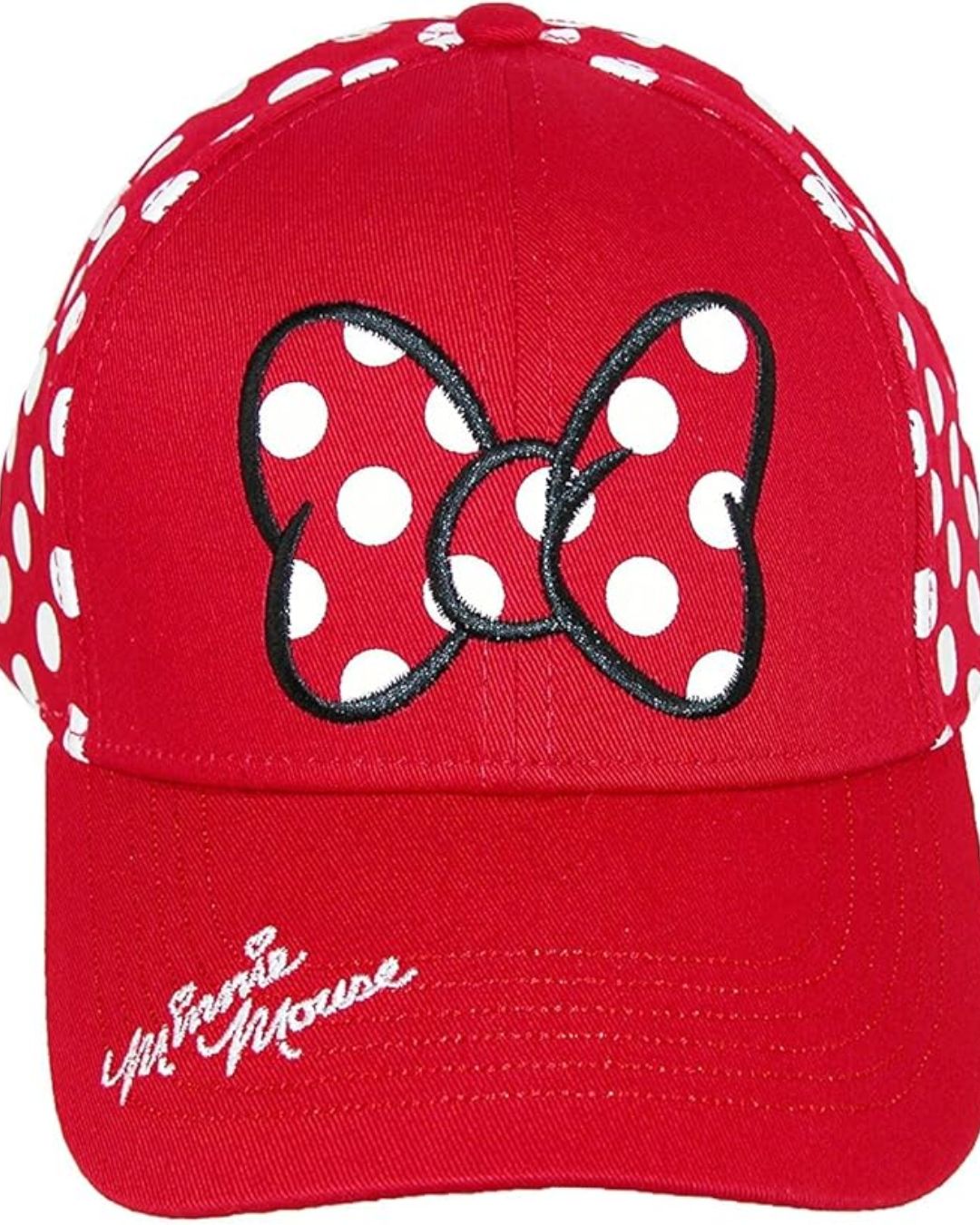Red baseball cap featuring a black-outlined bow with white polka dots on the front. The sides have polka dots, with a cursive logo on the brim. Playful tone.